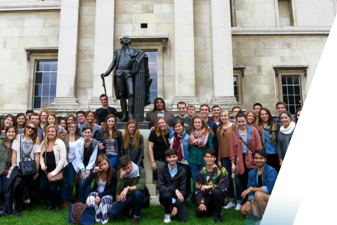 Large group of students posed with a statue